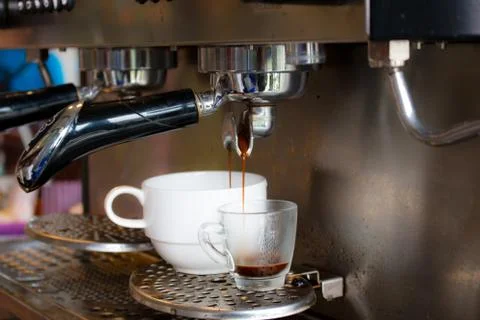 Coffee machine preparing fresh coffee and pouring  in cup Stock Photos