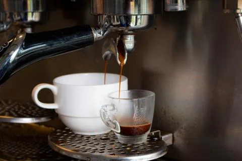 Coffee machine preparing fresh coffee and pouring  in cup Stock Photos