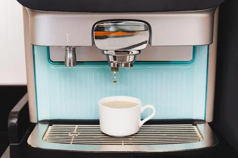 Coffee machine preparing fresh coffee into cups at restaurant. Stock Photos