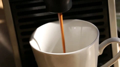 Coffee machine releasing  brewed coffee into cup Stock Footage 39243623