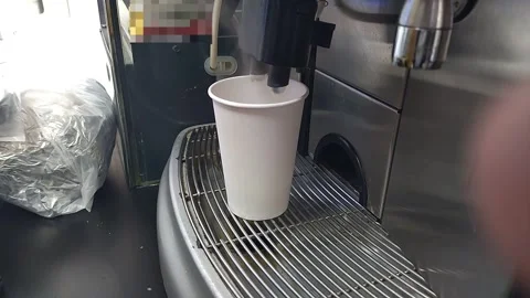 A coffee machine for self-service in a public place dispenses cream Видео 332609770