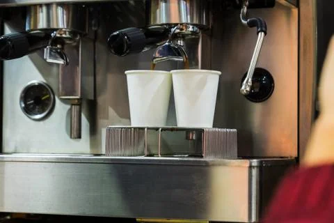 Coffee machine serving 2 coffees in a cardboard glass Stock Photos