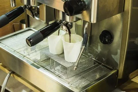 Coffee machine serving 2 coffees in a cardboard glass Stock Photos