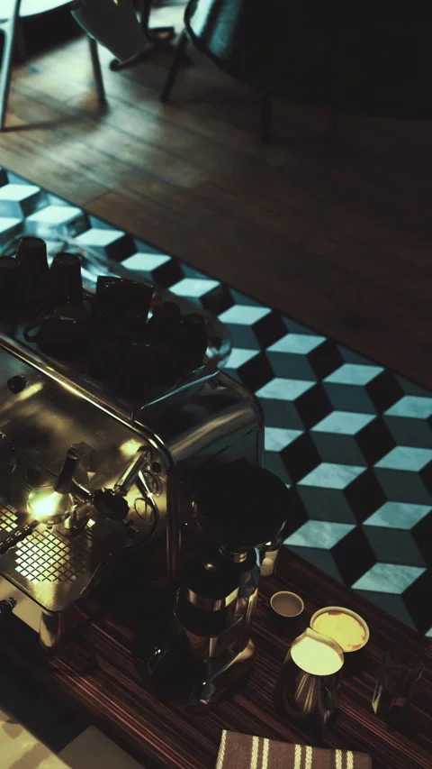 Coffee machine sits on a patterned floor in a cafe during evening hours Stock Footage 335450577
