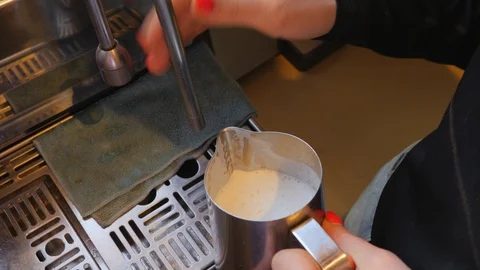 Coffee machine working barist heat and shake a milk for cappuccino Video stock 117796427