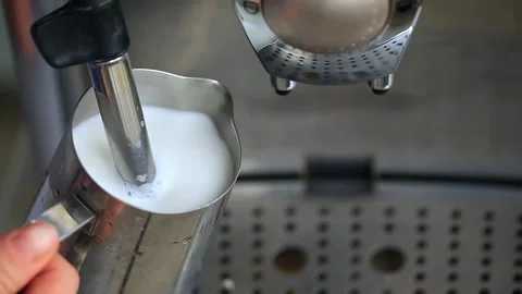 Coffee machine working heating and steaming the milk making foam for cappuccino. Stock Footage 142659902