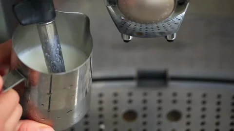 Coffee machine working heating and steaming the milk making foam for cappuccino. Stock Footage 142660546