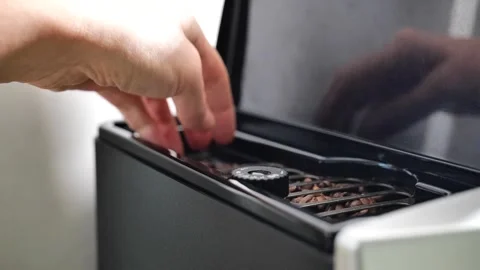 Coffee machine.hand pours coffee beans into the coffee machine Stock Footage 249268599