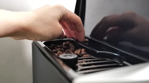 Coffee machine.Preparation of coffee stage.hand pours coffee beans Stock Footage 249268663