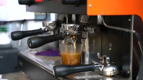 Coffee made in professional espresso machine hot pouring into a cup Stock Footage 140841503