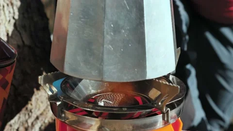 The coffee maker is installed on a portable gas burner and a flame is lit Stock Footage 144095329
