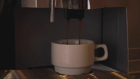 The coffee maker is pouring coffee Stock Footage 80725446