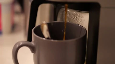 Coffee maker pouring espresso in a cup Video stock 328669434