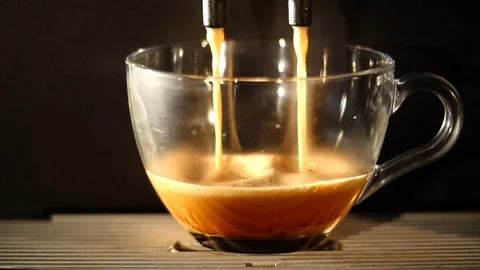 Coffee maker pours coffee into a cup. close-up Stock Footage