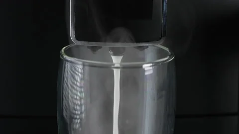 Coffee making machine dispensing milk into glass Stock Footage 171917165