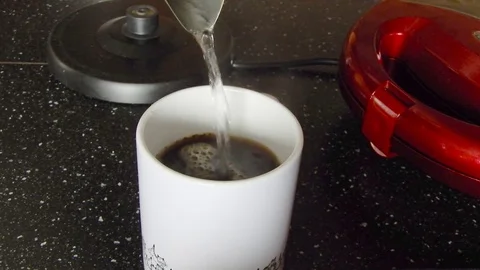 Coffee making in white cup on black table. 4K 30fps footage. Stock Footage 116039873