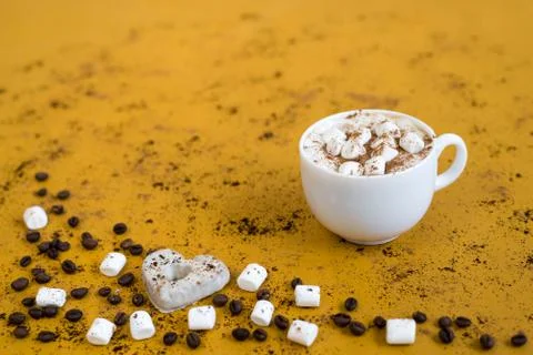 Coffee with marsh-mallows on yellow background 写真素材
