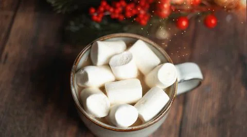 Coffee with marshmallows in a cup on the background of a Christmas decor Stock Photos