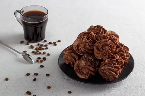 Coffee marshmallows on a light background in a plate, in the background is a Stock Photos