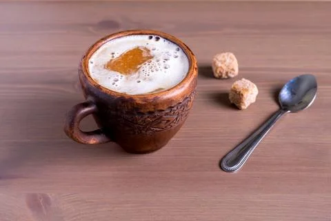 Coffee with milk in a fired earthenware mug Stock Photos