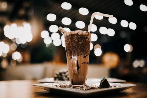 Coffee with milk on the table close up bokeh in the cafe Stock Photos