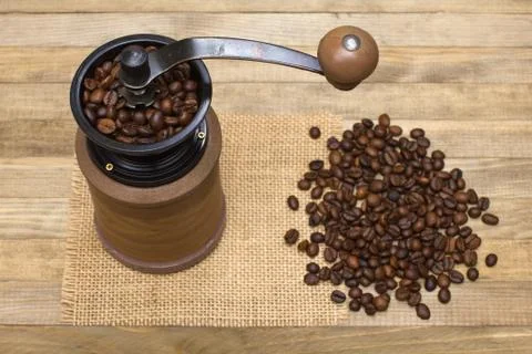 Coffee mill full coffee beans on wooden Stock Photos