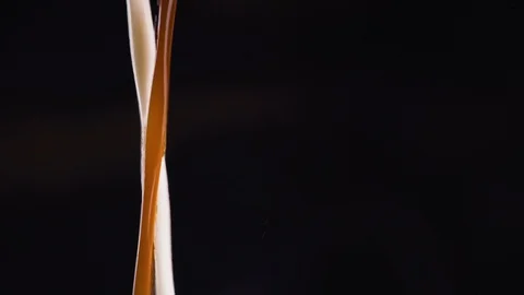 Coffee is mixed with milk Video stock 128546673