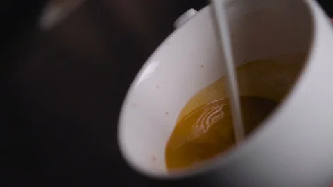 Coffee is mixed with milk Stock Footage 128546738
