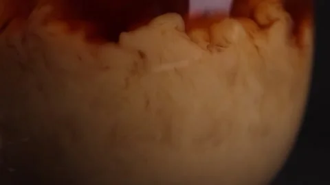 Coffee is mixed with milk slow motion bar Stock Footage 176389993