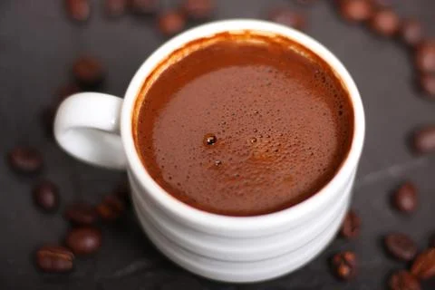 Coffee mug with coffee beans Stock Photos