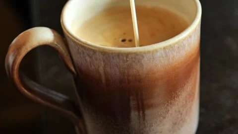 Coffee mug  with cream on black table. Stock Footage 244230229