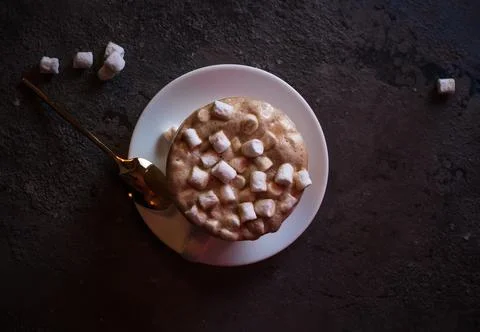 Coffee mug with marshmallows on a dark background top view Stock Photos