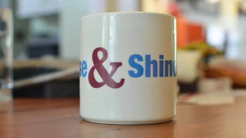 Coffee Mug Rotating on Table Rise &amp; Shine Stock Footage 79961780