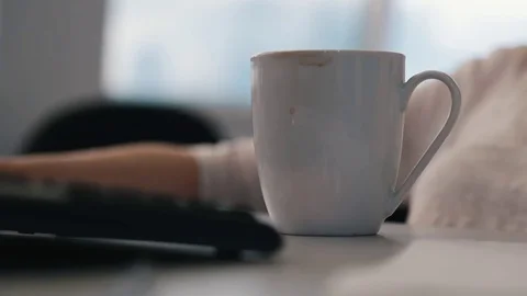 Coffee mug on the table with a journalist Stock Footage 75950493