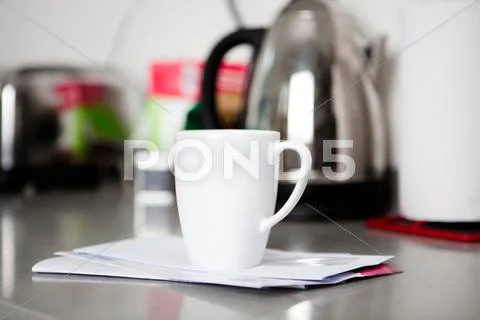 Coffee Mug On Top Of Envelopes