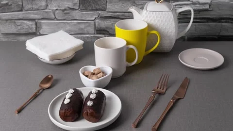 Coffee mugs, cake and a teapot appear and disappear Stock Footage 319963713