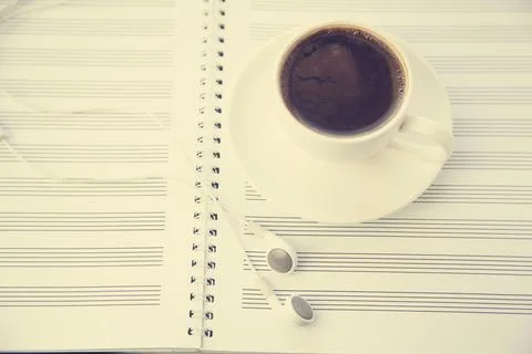 Coffee on musical notes notebook Stock Photos