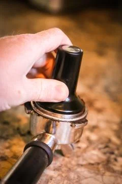 Coffee, or espresso making process - grinding and extracting coffee beans Stock Photos