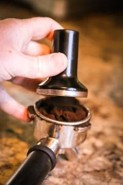 Coffee, or espresso making process - grinding and extracting coffee beans Stock Photos
