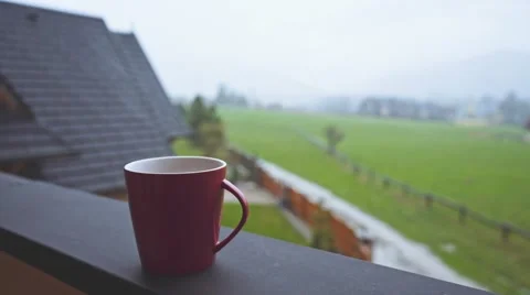 Coffee or Tea. Red Classic Cup of hot beverage Steaming Outdoors. 4K. Stock Footage 66756908