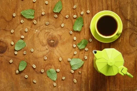 Coffee pattern green coffee beans and mint leaves Stock Photos