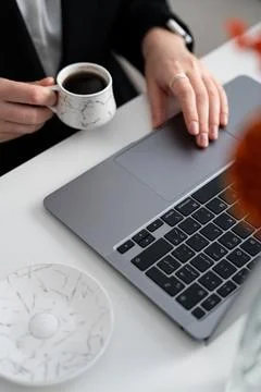 Coffee pause over laptop, minimal modern workspace Stock Photos