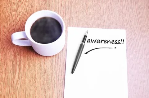 Coffee, pen and notes write awareness Stock Photos