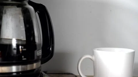 Coffee Pot and White Mug on Counter with Coffee Moving Swishing Sloshing Stock Footage 315803718
