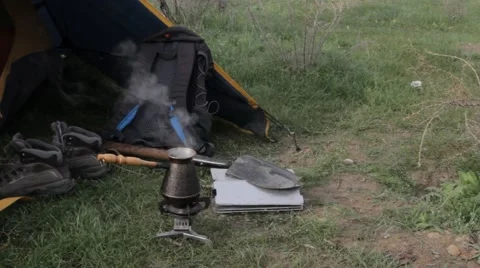 Coffee pot boiling on the hearth next to the tent Video stock 61907501