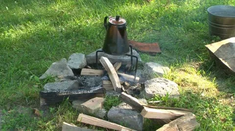 Coffee pot heating over a campfire Stock Footage 11195352