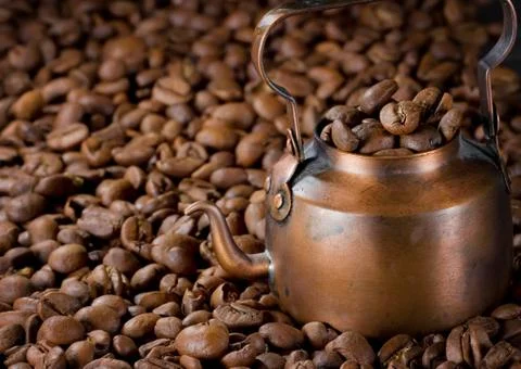 Coffee pot with light roasted coffee beans Stock Photos
