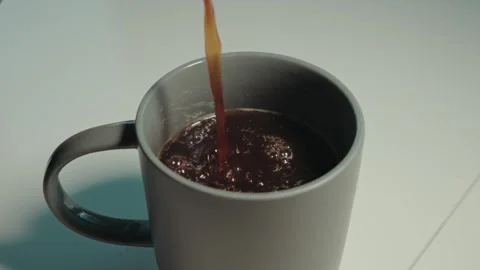 Coffee pour in gray cup white table Stock Footage 300204731