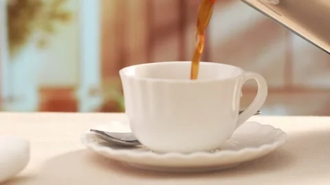 Coffee Pour into a white cup with steam on breakfast table. Stock Footage 270186990