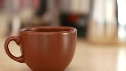 Coffee poured into a brown cup. Stock Footage 70400168